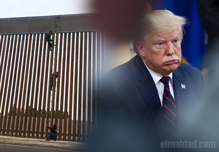 Migrante saltando el nuevo muro de Trump.